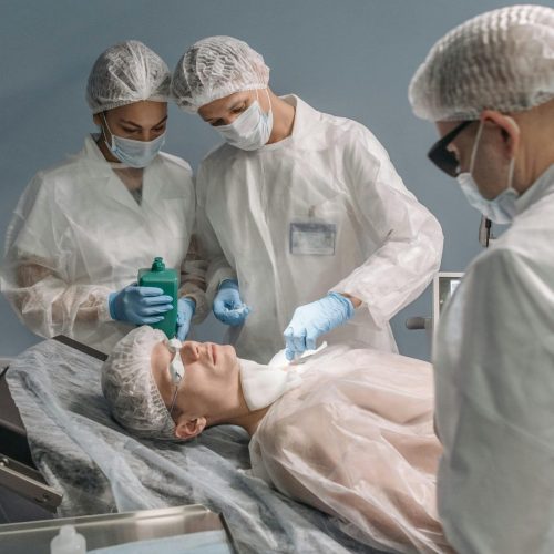pexels-photo-7108265-7108265 Medical professionals conducting a surgical procedure in a hospital operating room.